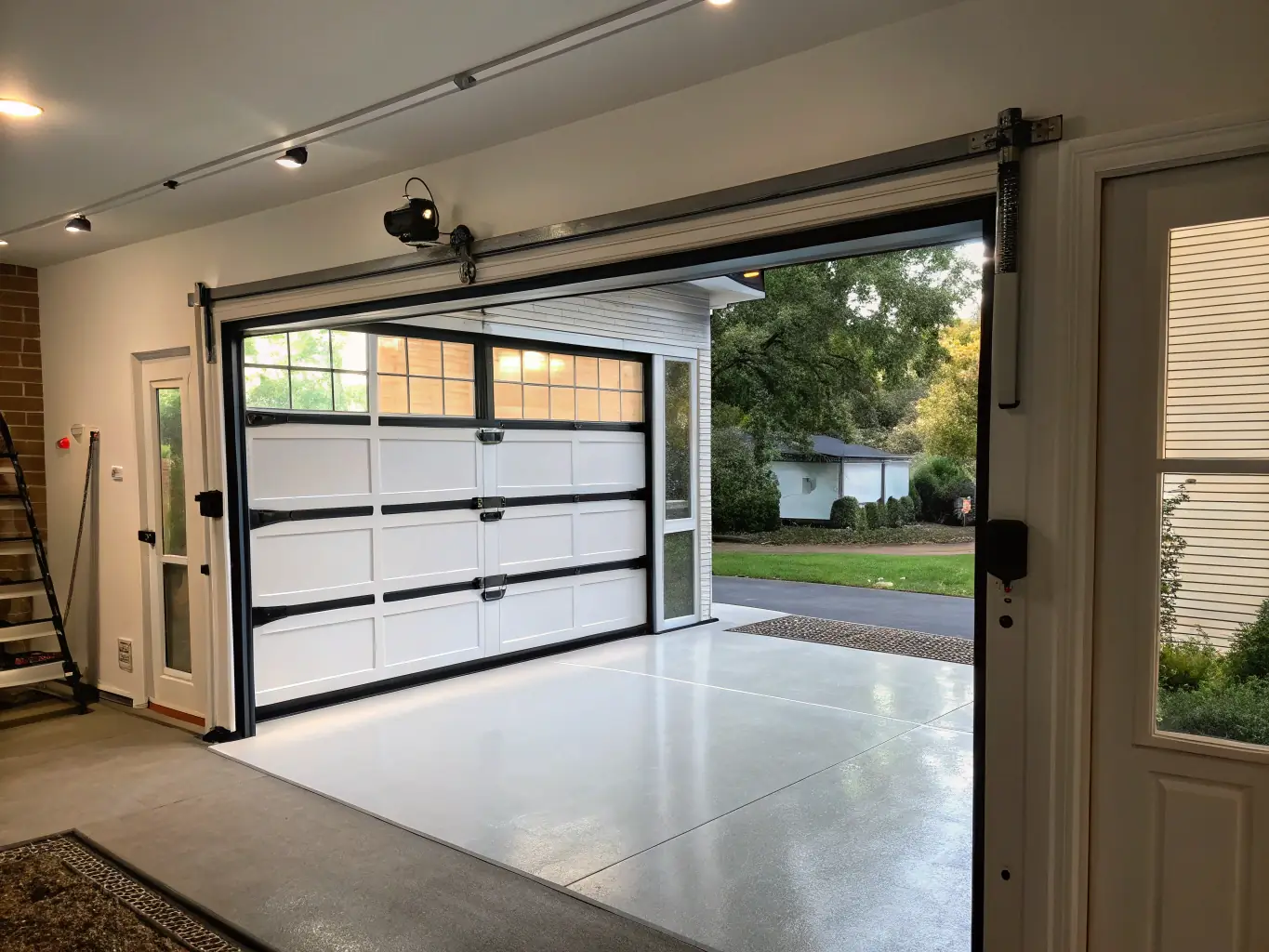 A newly installed, modern-looking garage door enhancing the curb appeal of a residential home. The door is a light gray color and complements the home's exterior.